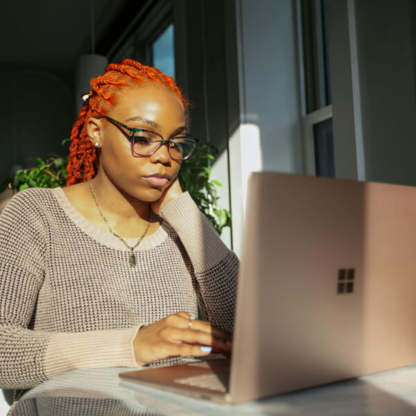 Lady in glasses working at laptop