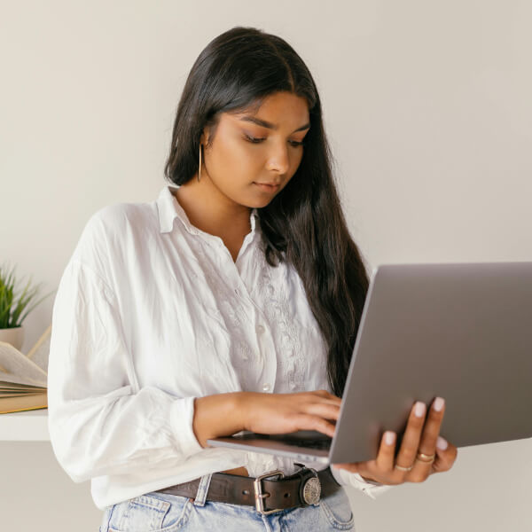 Lady standing using laptop