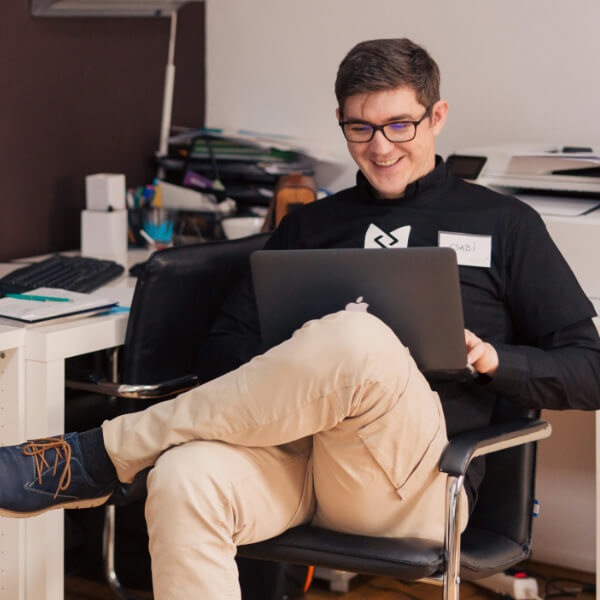 Man smiling at laptop
