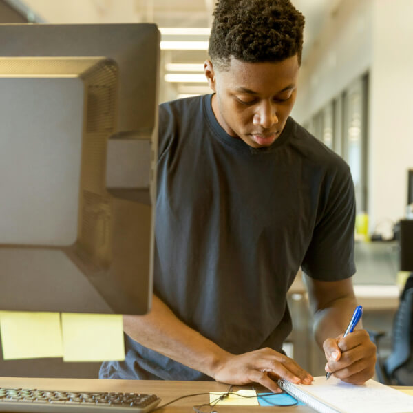 Man taking notes at desk